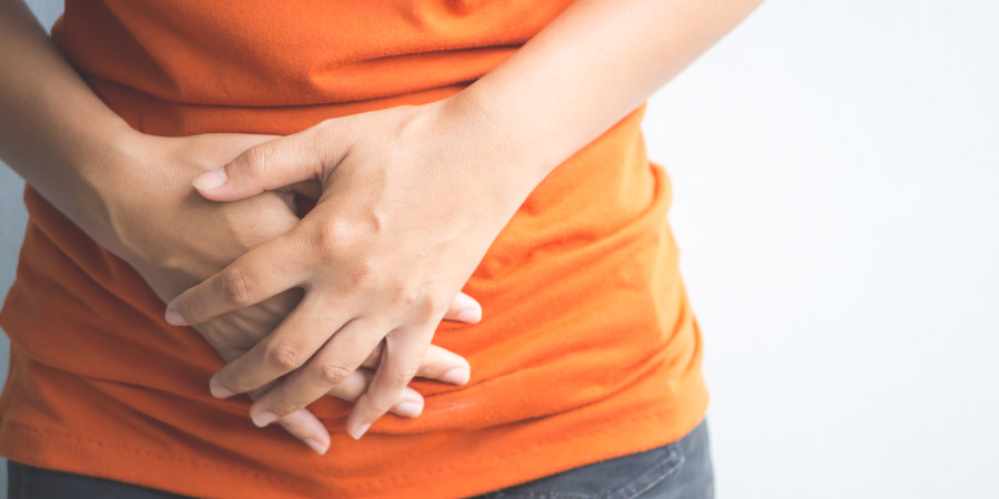 Young woman having painful stomachache.